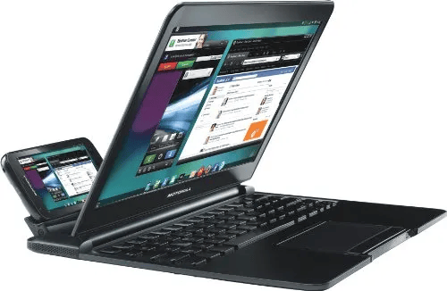 A black laptop with a detachable smartphone docked on its side, displaying multiple application windows on the screen.